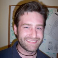 Bill Lamar Smiling man with short hair and scruffy facial hair